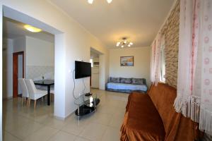 a living room with a couch and a table at Apartments Šuperba in Brodarica