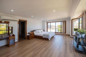 a large bedroom with a bed and a television at 6bed Macgregor Home in Brisbane