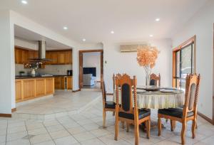 a kitchen and dining room with a table and chairs at 6bed Macgregor Home in Brisbane