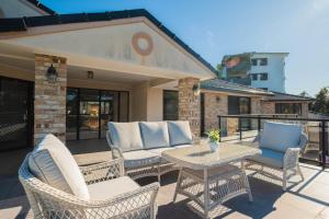 a patio with wicker chairs and a table at 6bed Macgregor Home in Brisbane
