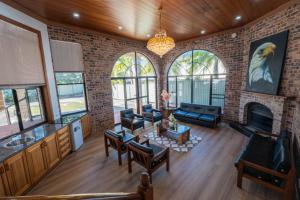 a living room with a brick wall at 6bed Macgregor Home in Brisbane
