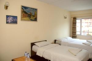 Postel nebo postele na pokoji v ubytování Kathmandu Madhuban Guest House