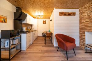 a kitchen with a counter and a chair in a room at Les cols in Sainte-Marie-de-Cuines
