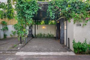 an entrance to a building with a gate with plants at Paradise in the Heart of Seminyak! in Seminyak
