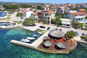 an aerial view of a private island in the water at Apartments Šuperba in Brodarica