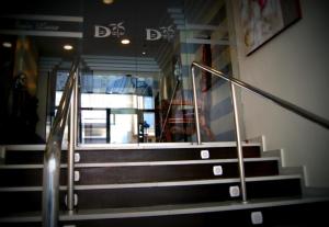 a set of stairs in a building with a person walking up it at Hotel Doña Luisa in San Luis de Sabinillas