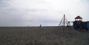 a playground on a beach with a person in the background at Hotel Doña Luisa in San Luis de Sabinillas