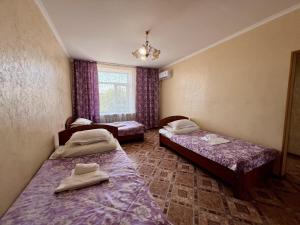 a room with two beds and a window at Гостиница Караганда in Karagandy +40 photos