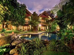 an exterior view of a house with a swimming pool at Duta Boutique Villa in Yogyakarta