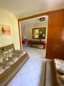 a bedroom with a bed and a living room at Village Japara in Ilhéus +21 photos