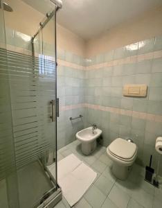 a bathroom with a toilet and a sink at MaGio House in Iseo
