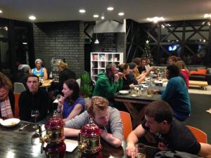 a group of people sitting at tables in a restaurant at The Phat House in Hakuba