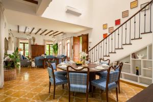a dining room with a table and chairs at La Morena by The Blue Kite - Luxurious & Spacious 4 BHK villas in Assagao, Private Pool, Balcony, Kitchen, Patio and Security in Assagao +154 photos