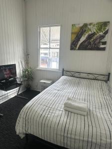 a bedroom with a large bed with a white comforter at Melbourne Street, South Brisbane in Brisbane