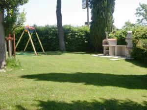 a playground in a yard with a swing at Casina Pian Di Monetto in Montefiascone