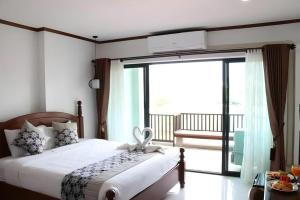 Ένα ή περισσότερα κρεβάτια σε δωμάτιο στο Thavisouk Riverside Hotel