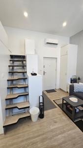 a living room with a spiral staircase in a room at Studio Gea in Semedela +3 photos