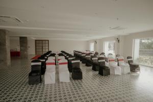 a room with chairs lined up in a building at BANMALI PALACE in Kantābānji
