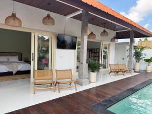 a villa with a bedroom and a swimming pool at Villa Kuu - Elegant 2BR Villa with Private Pool in Kerobokan