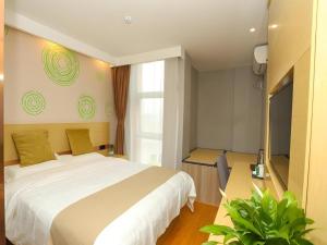 a bedroom with a large white bed and a window at GreenTree Inn Suzhou Changshu Southeast Development Zone Southeast Avenue in Gujiashuigou