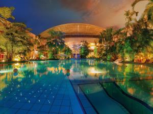a swimming pool in front of a building at night at Döllelhof Erding in Erding