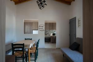 a kitchen and dining room with a table and chairs at Luxury Central Beach House in Kithnos