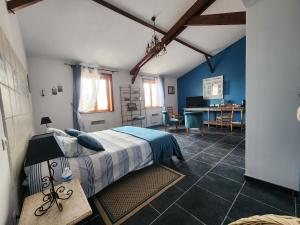 a bedroom with a bed and a desk in it at Ferme de la Forterie Verlinghem in Verlinghem