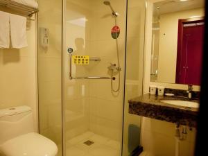 a bathroom with a shower and a toilet and a sink at GreenTree Inn Rizhao Haiqu East Road Hotel in Rizhao +137 photos