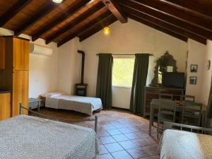 a room with two beds and a tv and a window at Agriturismo Argentea in Arenzano +88 photos