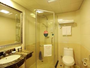 a bathroom with a shower and a toilet and a sink at GreenTree Inn Hefei Chenghuangmiao San Xiao Kou Subway Station Hotel in Hefei +50 photos