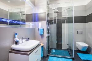 a bathroom with a sink and a shower at Opera Luxory Suite in Budapest