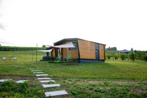 a tiny house in a field with a pathway at Seosko Domaćinstvo Protic , Prijedor , Veliko Palančište in Velika Palančište