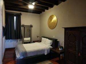 a bedroom with a bed and a clock on the wall at la casa positos in Guanajuato