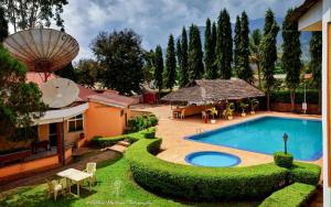 a house with a swimming pool in a yard at Hotel Oasis in Morogoro