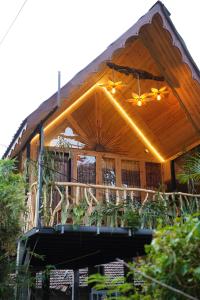 a house with a porch with lights on it at Gisban Wood Cabana & Hostel in Habarana