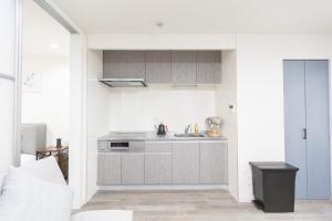 a kitchen with a sink and a counter at b&岸里店 in Osaka