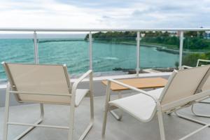 two chairs and a table on a balcony with the water at Elite Family Hotel in Kiten +37 photos