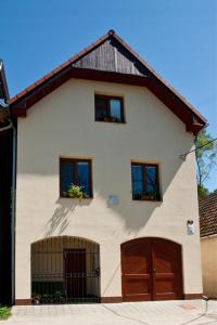 a white house with two windows and a garage at Chalupa - Sklep Starovice in Starovice