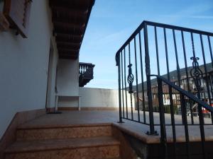 a balcony with stairs and a view of a building at Casa Sassdei in Cavedago