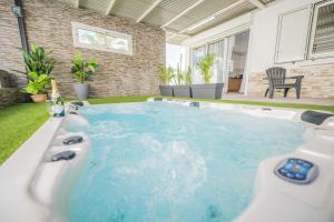 a hot tub in the backyard of a house at Villa Noé - Famille, détente et Jacuzzi - Wiskeys in Commune Bègue