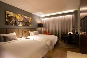 Ένα ή περισσότερα κρεβάτια σε δωμάτιο στο Yitel Premium Hotel Shanghai Xuhui +207 φωτογραφίες