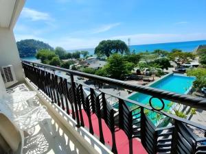 a balcony with a view of a swimming pool at HW Hotel Padang in Kampungdurian
