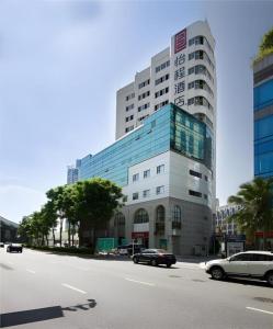a large building with cars parked in front of it at Echeng Hotel Xiamen Zhongshan Road in Xiamen
