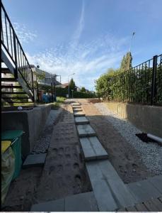 a walkway with a fence and stairs on a street at SeaSide in Gdańsk +2 photos