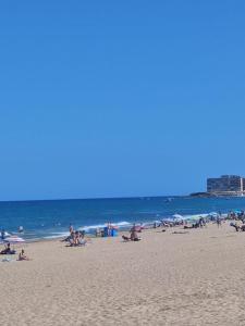a group of people on a beach with the ocean at Casa Marius in La Mata +4 photos