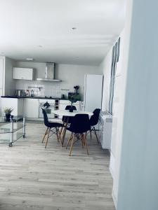 a kitchen and dining room with a table and chairs at Petit coin tranquille a 2 pas de strasbourg in Strasbourg