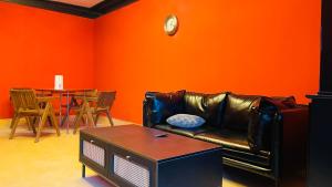 a living room with a leather couch and a table at The house where time is wasted under the road in Chongqing