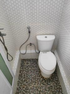 a bathroom with a toilet and a shower at Lawang Rinjani in Sembalun Lawang