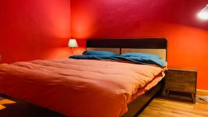 a red bedroom with a bed with a red wall at The house where time is wasted under the road in Chongqing