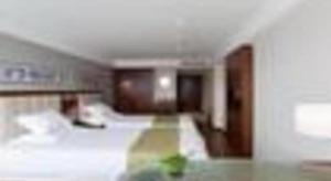 Yitel Collection Hangzhou Binjiang Jiangnan Avenue Baolongcheng客房内的一张或多张床位